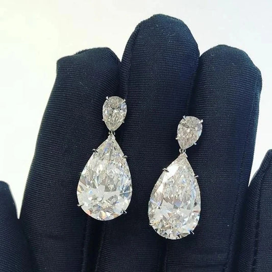 Pear-shaped cubic zirconia dangle earrings with small top stone, silver-tone.