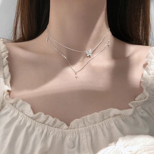 Layered butterfly necklace set with silver-tone chains and small sparkle charms