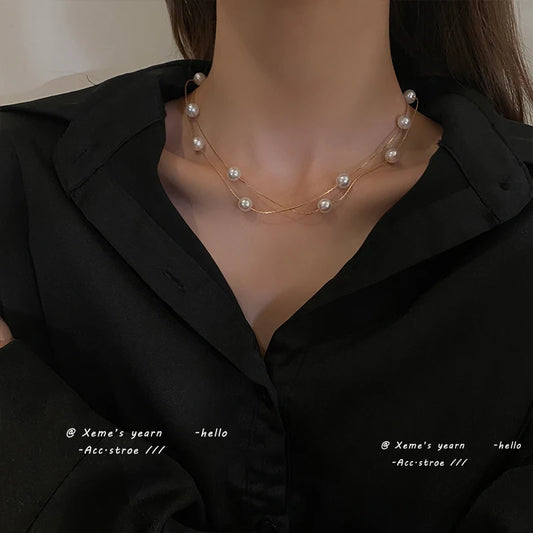 Gold-tone double-layer pearl choker necklace with pearls spaced along two strands