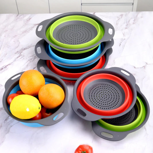 Stacked silicone folding colanders, gray frames with green, blue and red strainer inserts