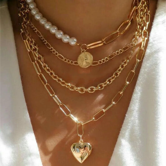Gold layered chain necklace with pearl strand and small heart pendant
