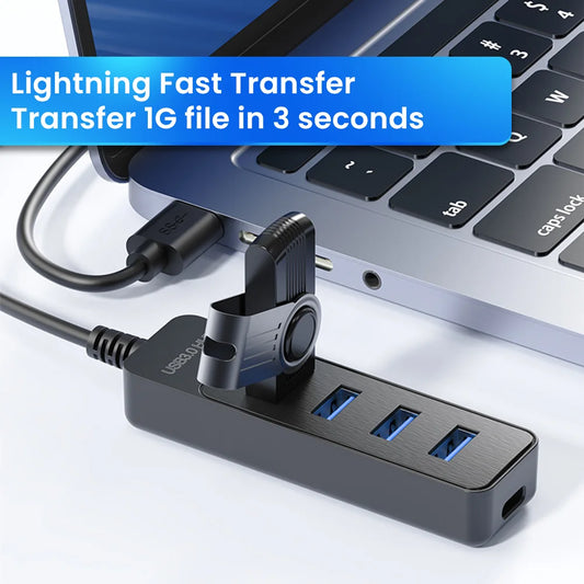 USB 3.0 4-port hub showing four blue-lit USB-A ports connected to a laptop