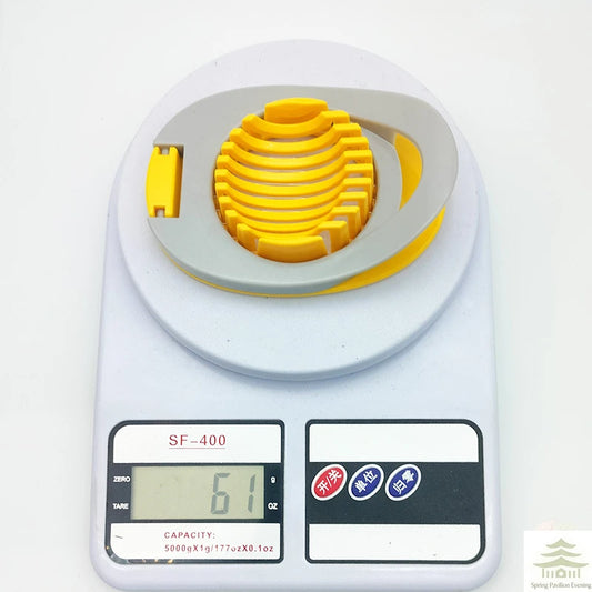 Yellow egg slicer with ridged stacked disc, white base and scale display