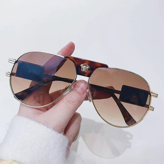 Tortoise aviator sunglasses with gradient lenses and bull-head temple emblem