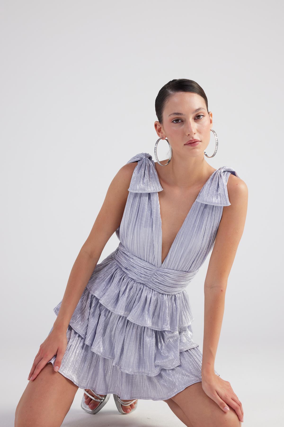 Light blue shiny pleated mini ruffle dress detail, deep V-neck and tiered layers