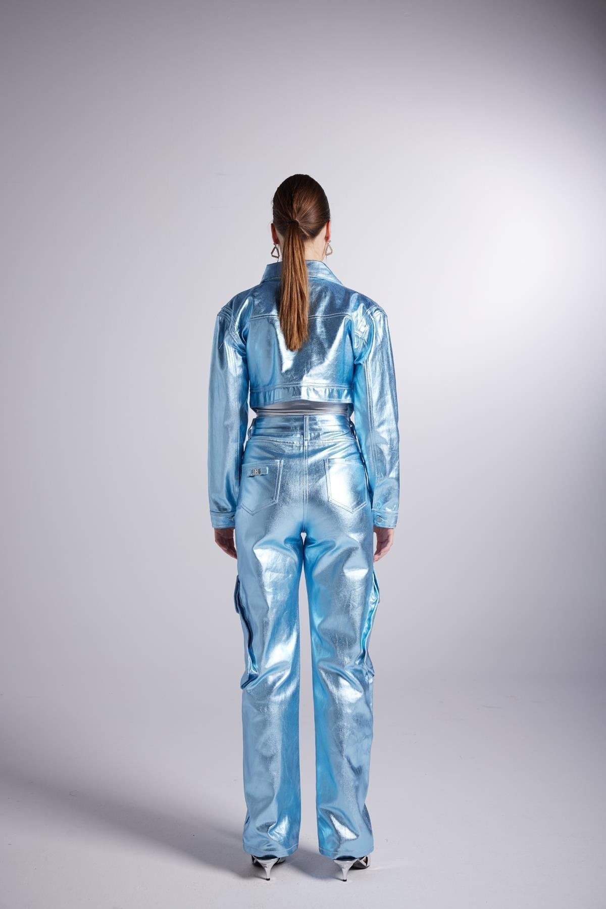 Metallic glossy blue cropped jacket, back view with button closure and collar