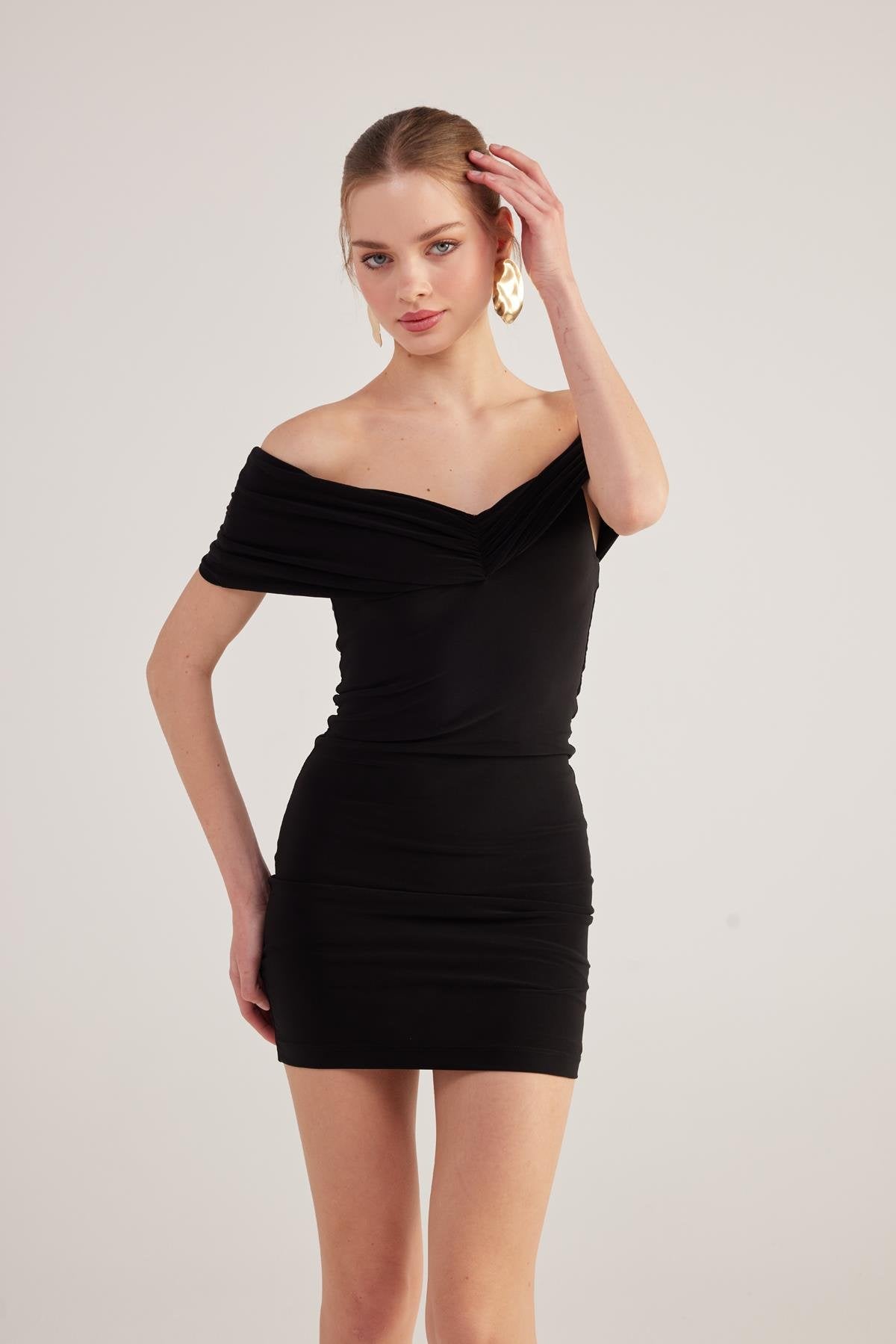 Black off-shoulder bardot mini dress with fitted waist and ruched bodice