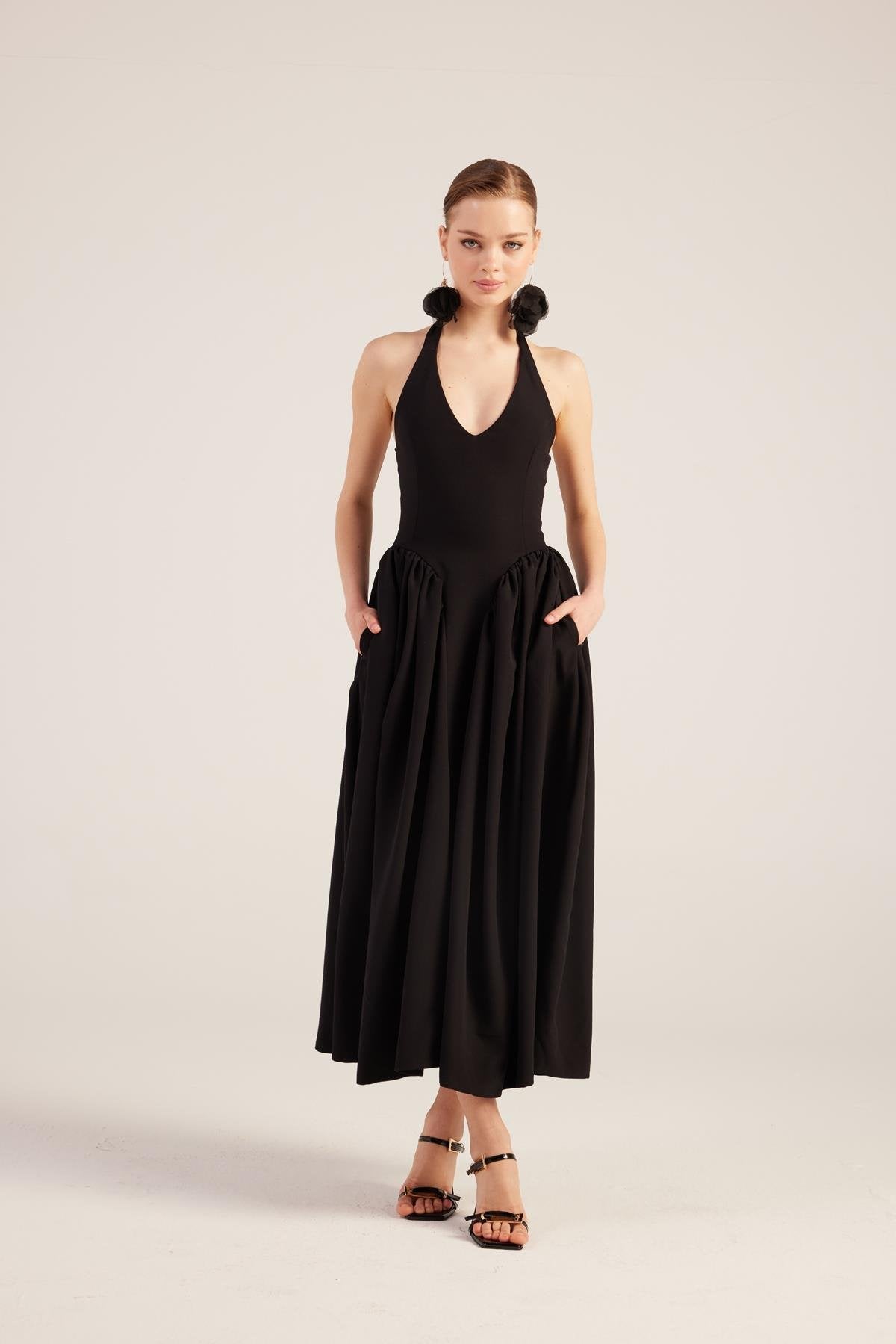Black princess style maxi dress with sleeveless bodice and pleated skirt