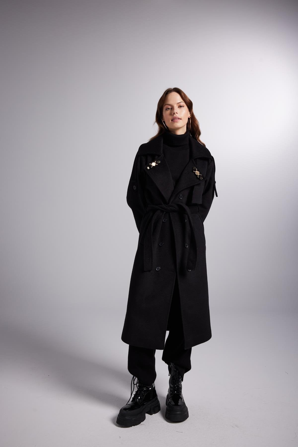 Black maxi coat with belted waist tie, high neck, gold-tone details