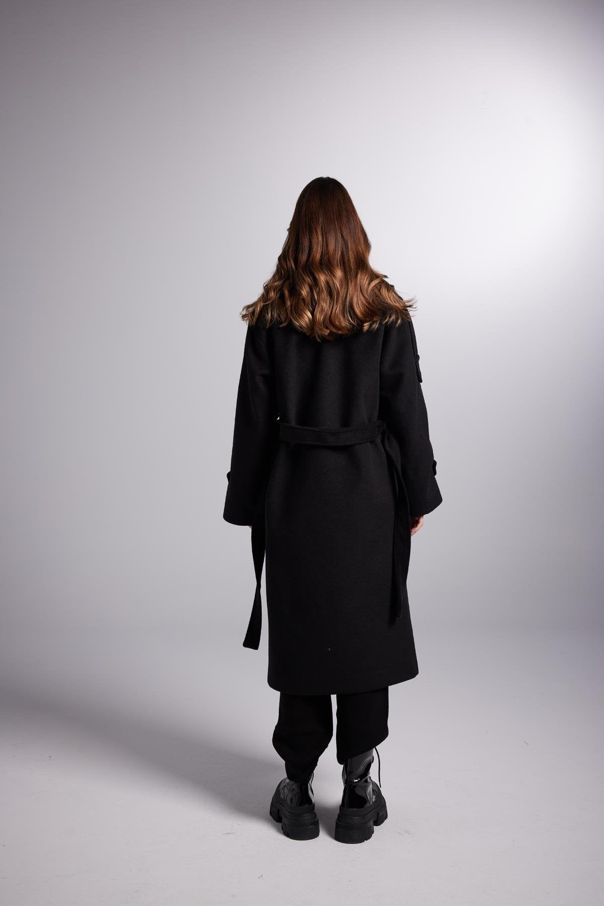 Back view of black maxi coat with belt tie and long sleeves