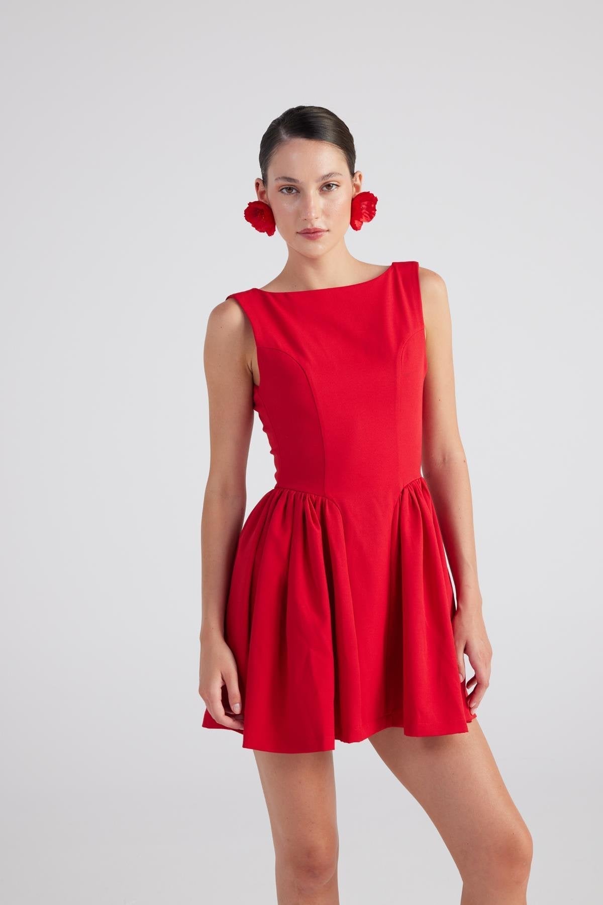 Red sleeveless pleated mini dress with gathered waist and round neckline