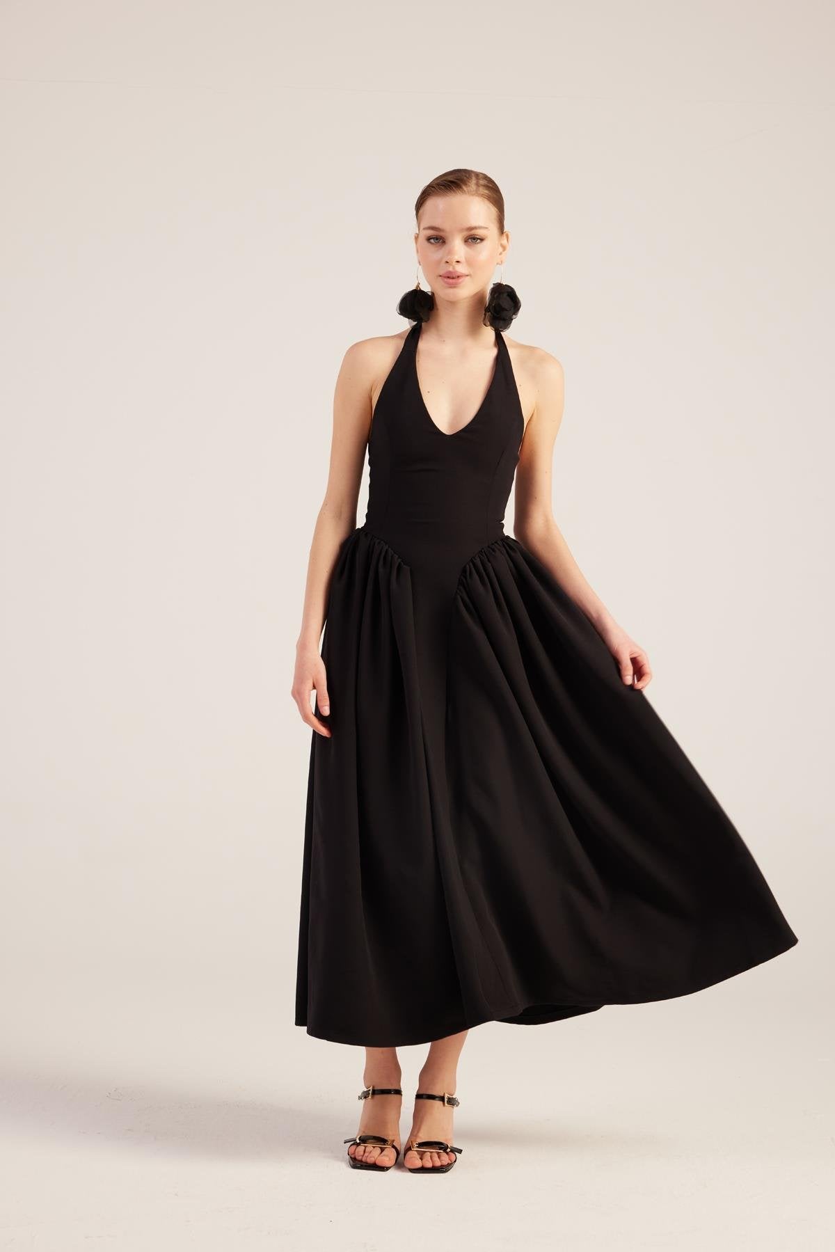 Black halter maxi dress with full gathered skirt and deep V front