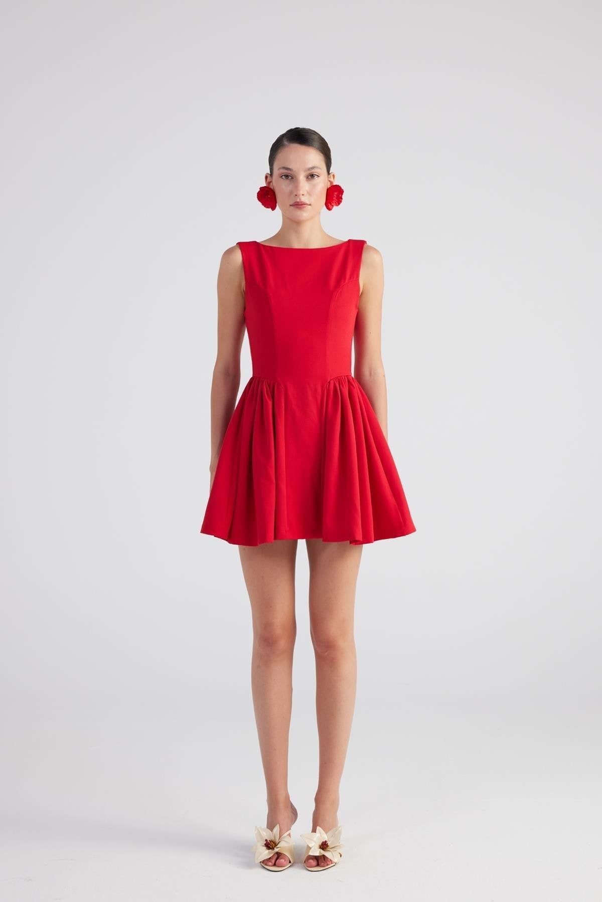 Red sleeveless pleated mini dress with flared skirt and round neckline