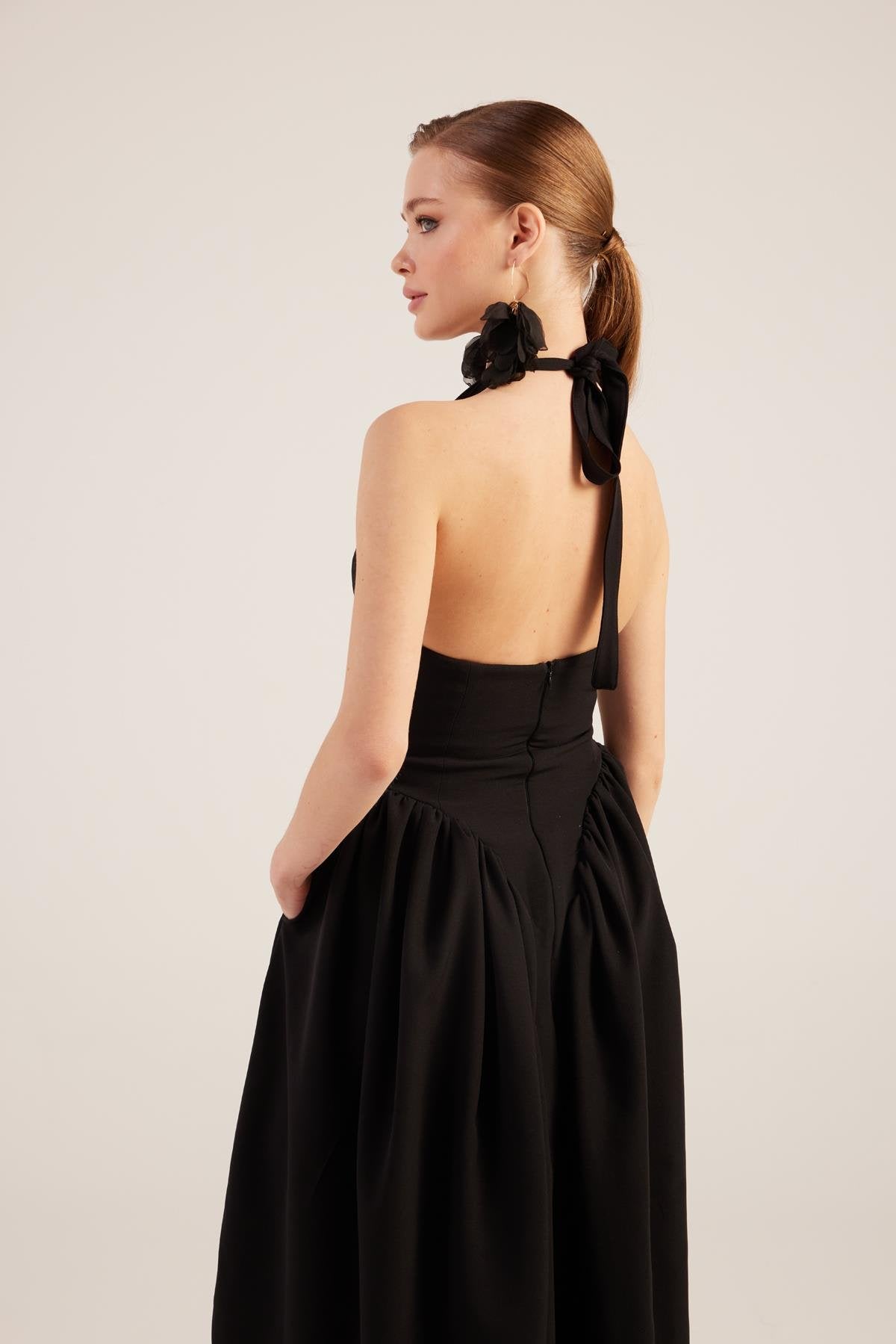 Black halter maxi dress back view with open back and bow detail