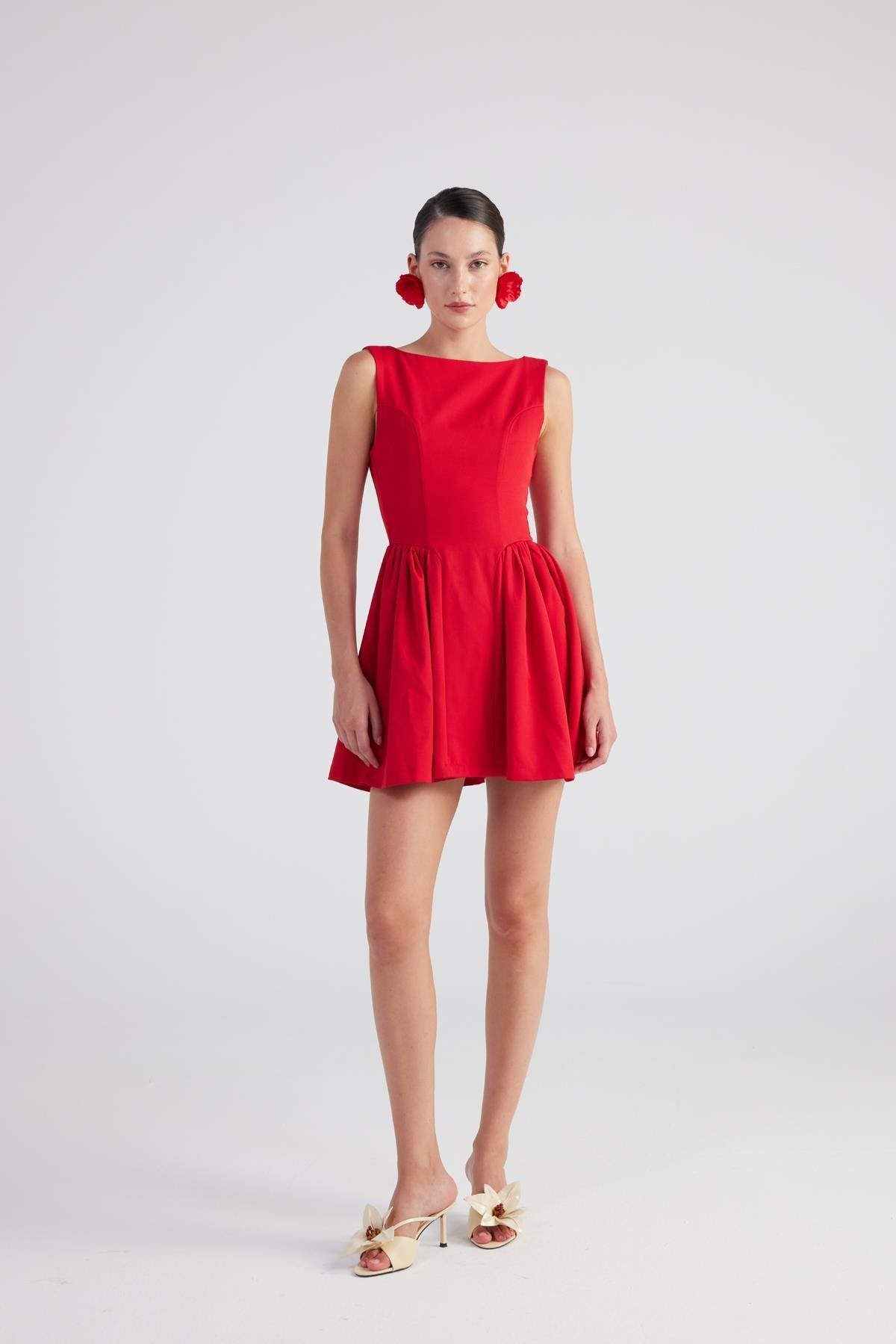 Red sleeveless pleated mini dress with gathered waist, front angled view