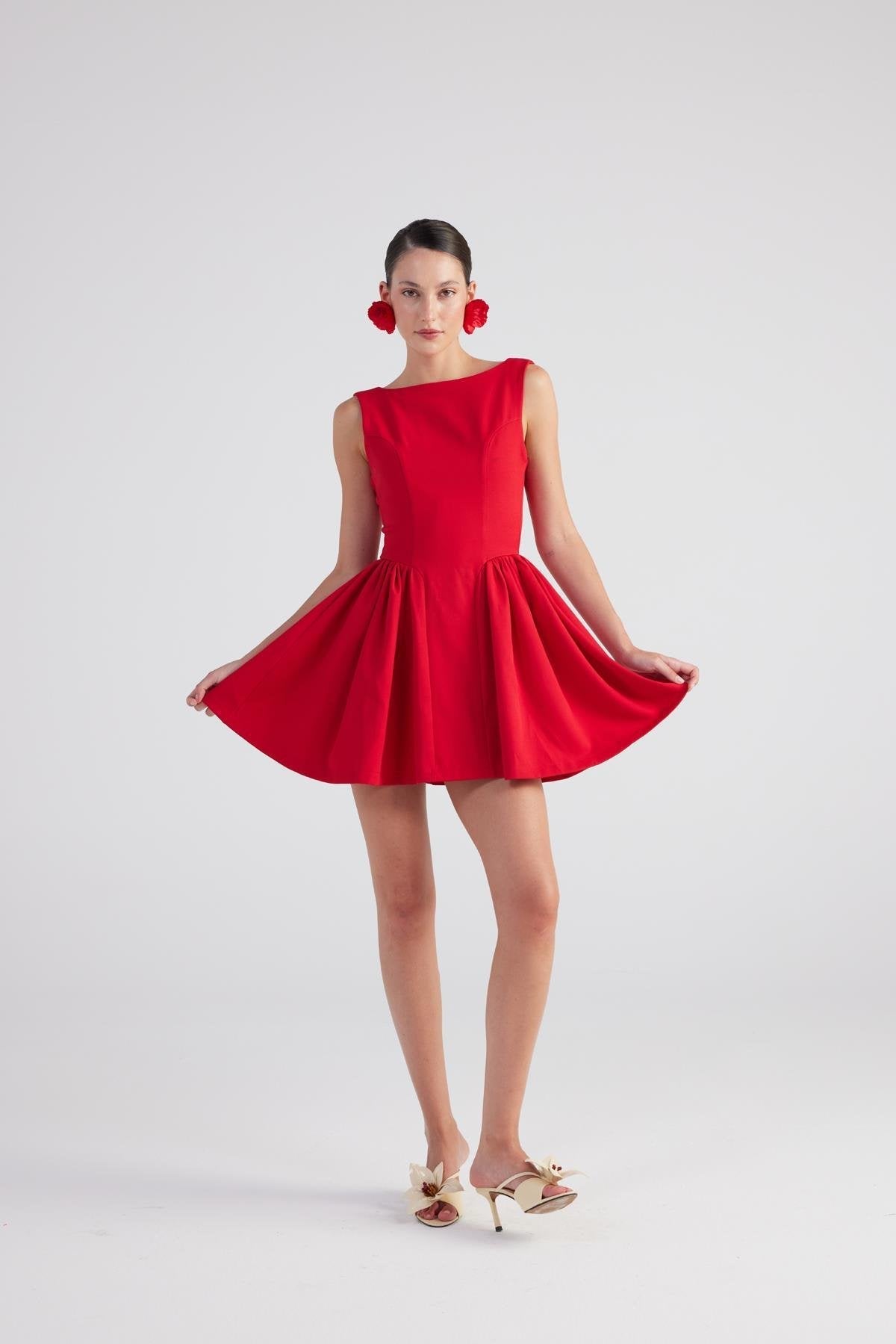 Red sleeveless pleated mini dress with wide flared skirt and gathered waist