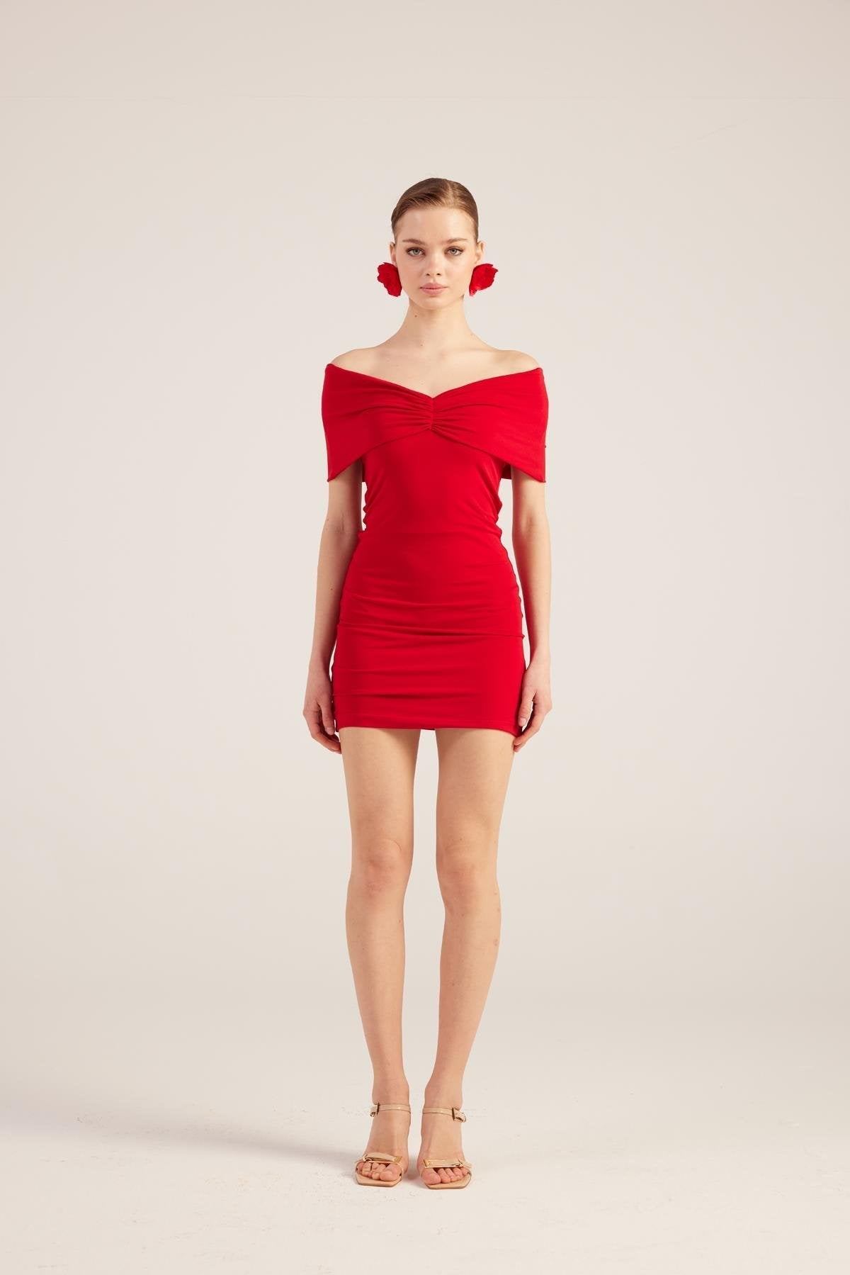 Red off-shoulder mini dress with draped neckline, ruching at waist and fitted skirt