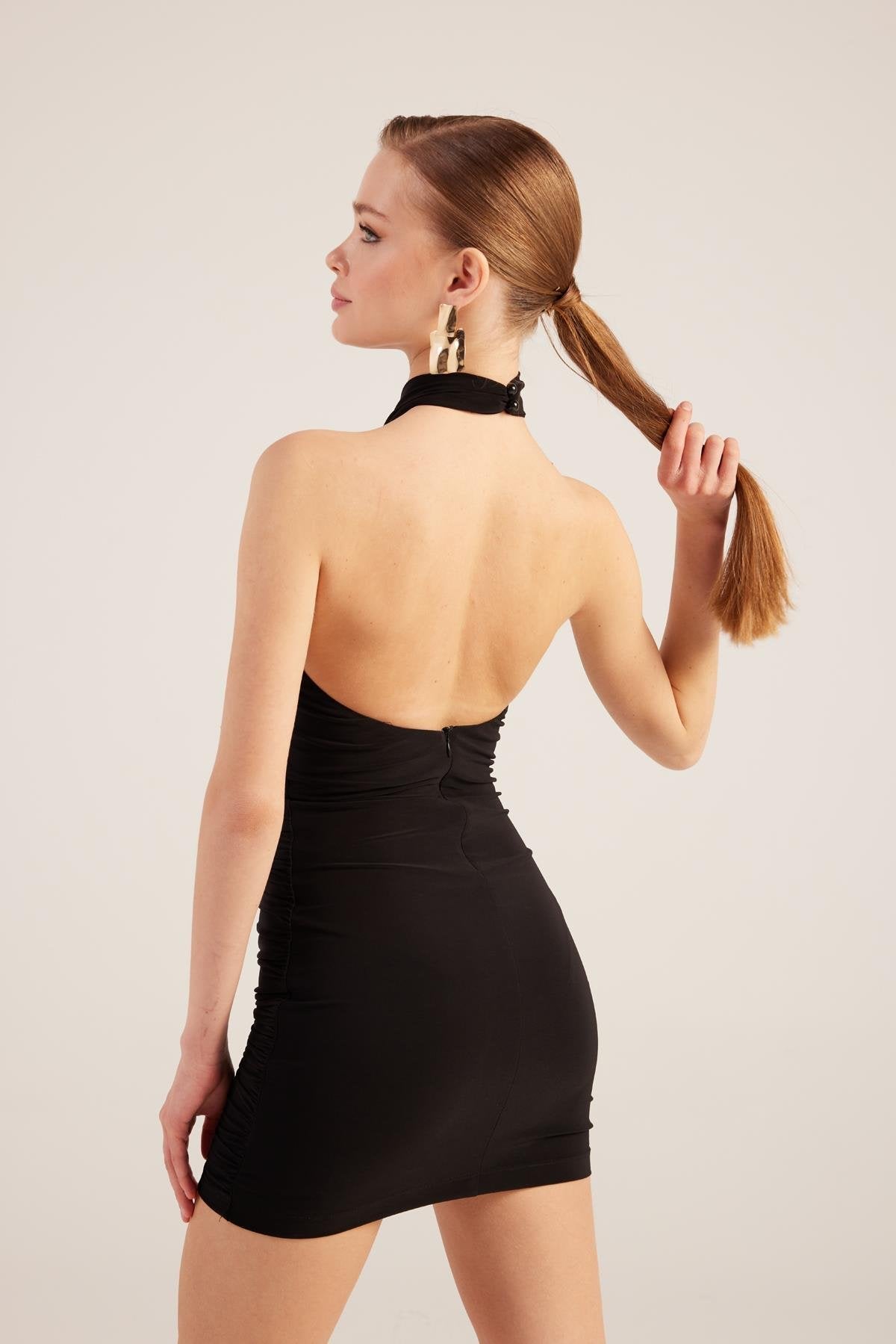 Black halter neck mini dress, open back and ruched waist