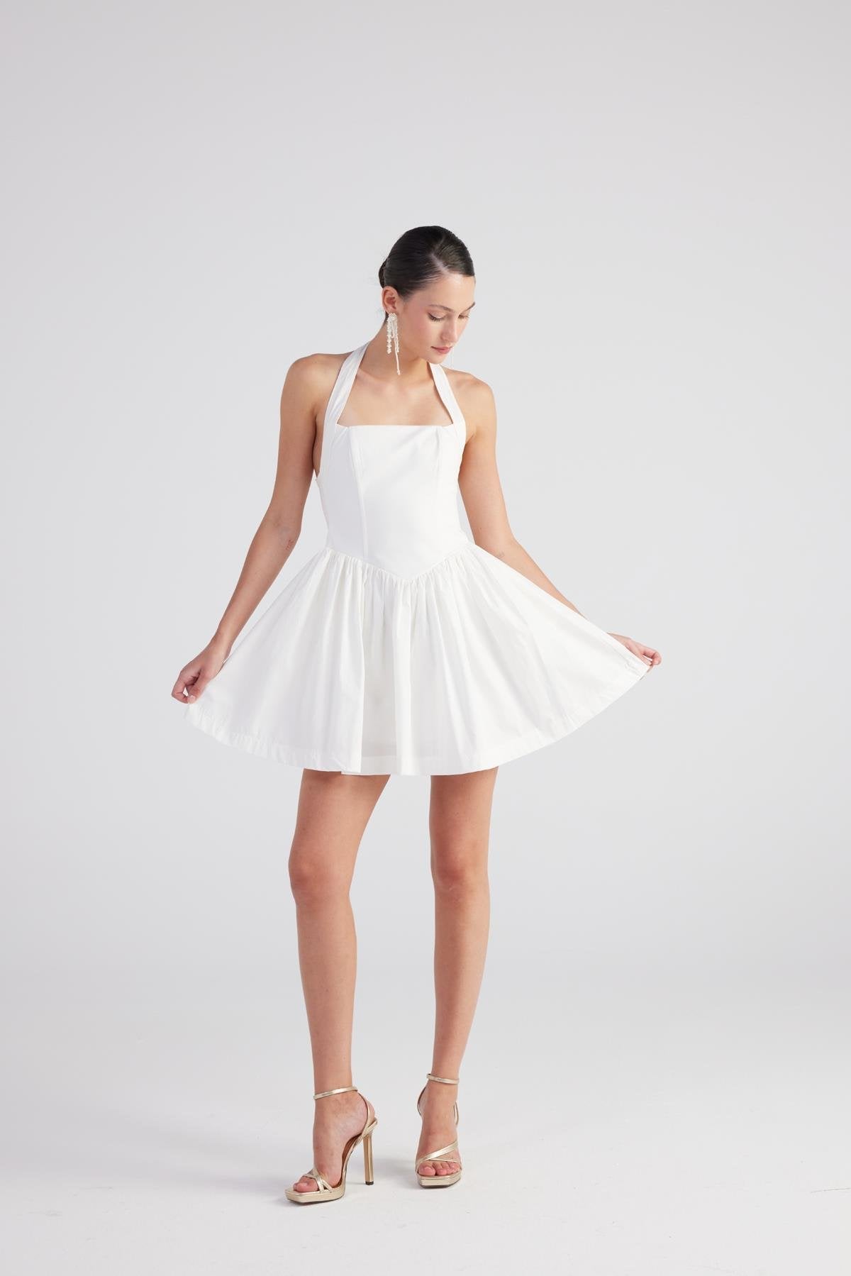 White pleated mini dress with square neckline and thin straps, gathered waist