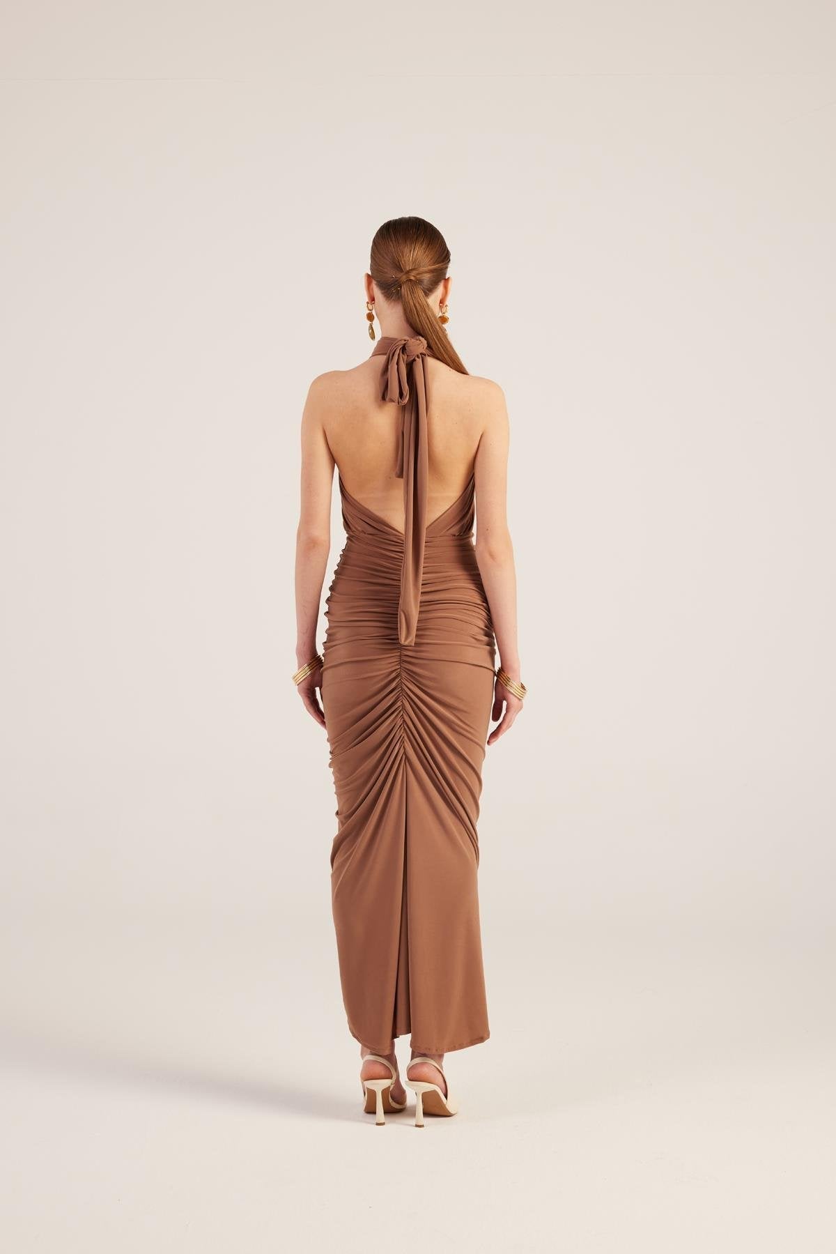 Brown backless halter maxi dress with ruched sides and long center-back tie