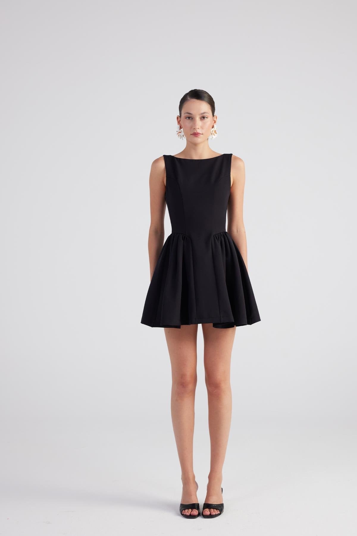 Black sleeveless pleated mini dress with fit-and-flare skirt and gathered waist