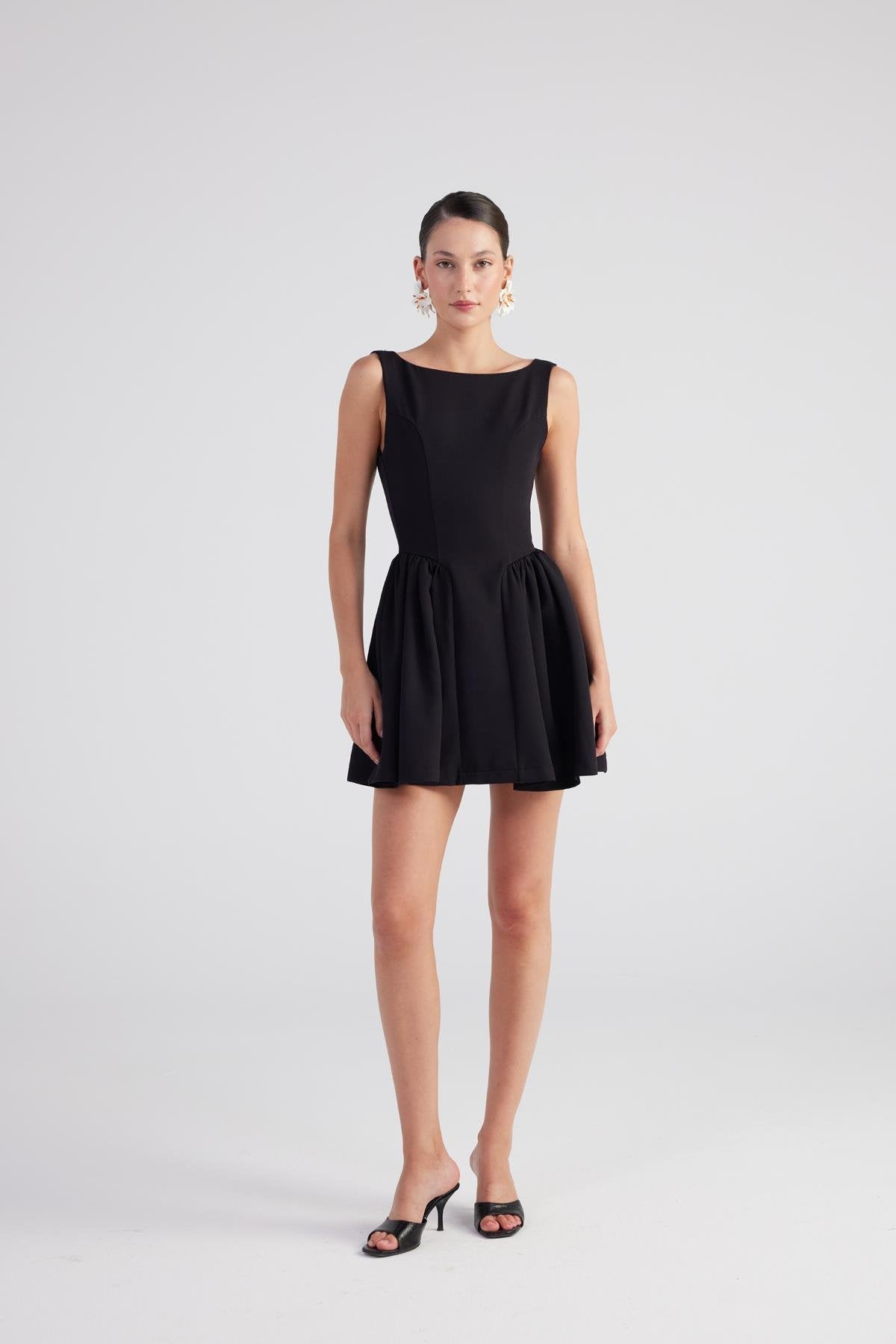 Black sleeveless pleated mini dress, wide skirt with gathered waist