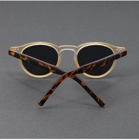 Cat-eye sunglasses with translucent cream front, dark lenses, and tortoise side arms