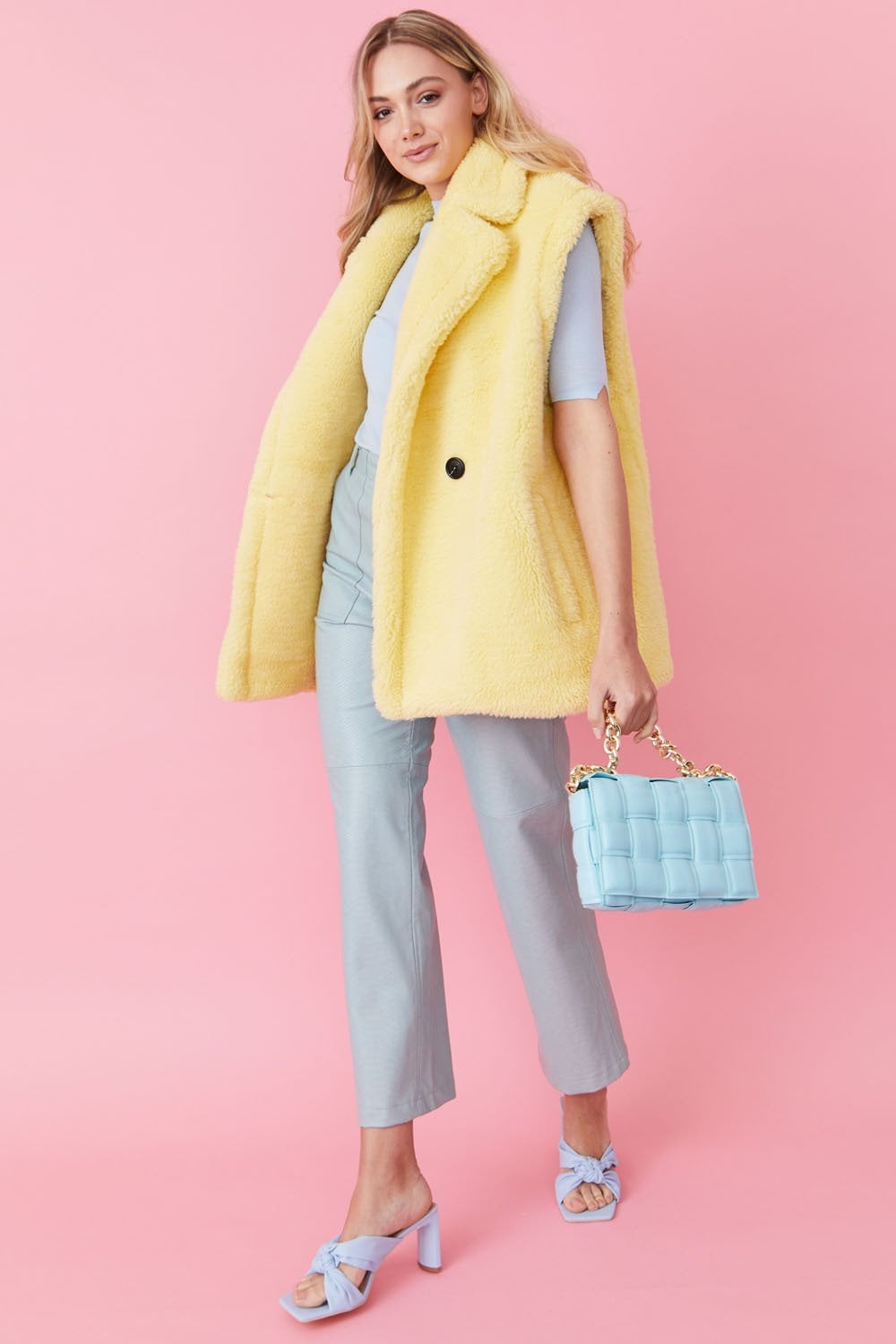 Light blue faux leather cross-body bag with gold chain strap, small woven panel shape