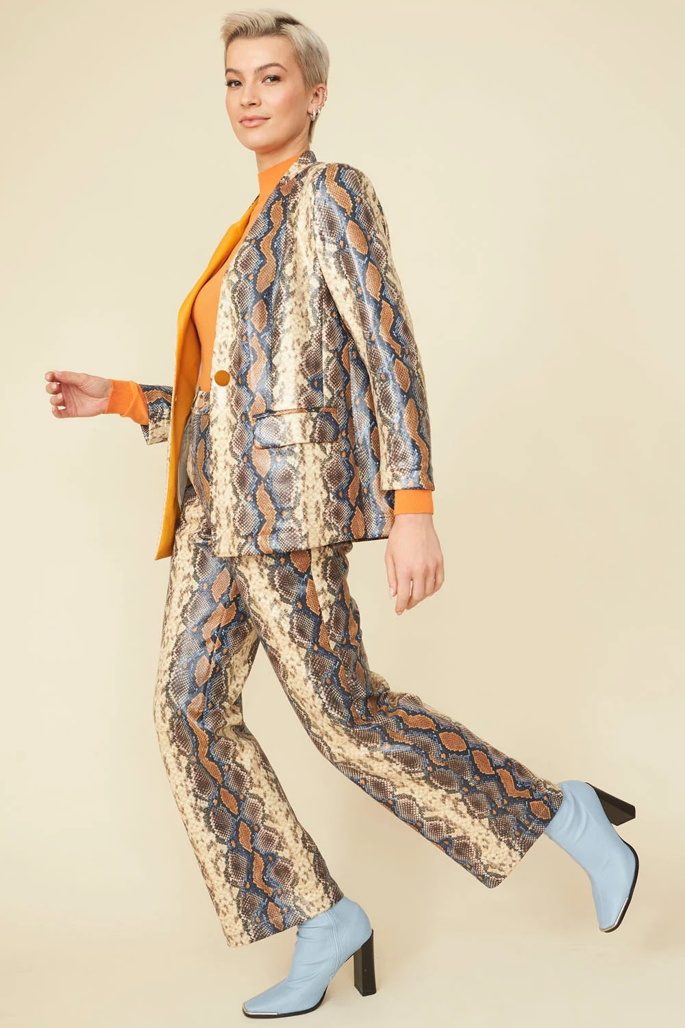 Snake print faux suede wide-leg trousers, blue and tan scales, side view