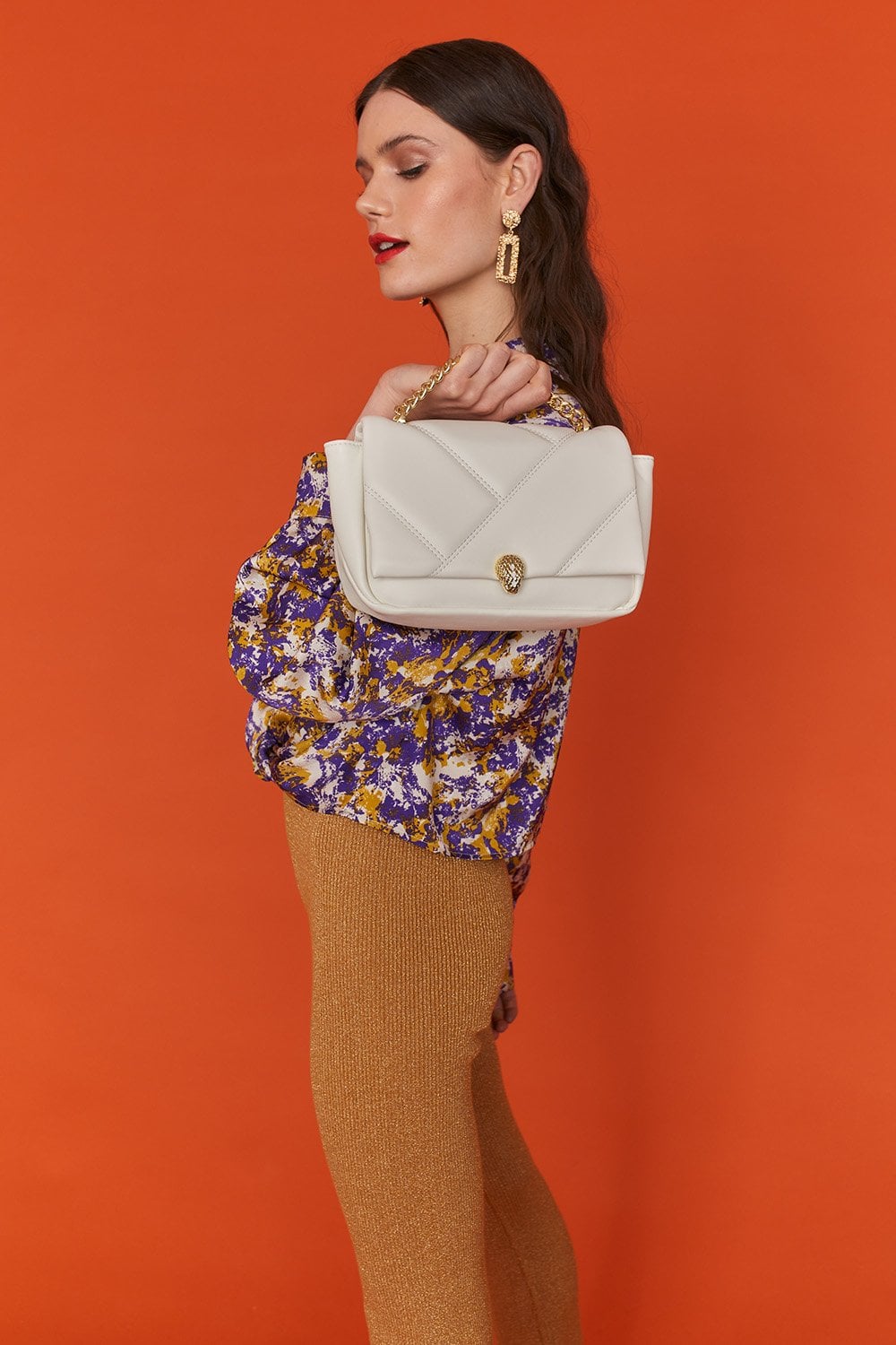 White quilted faux leather shoulder bag with gold-tone clasp under flap