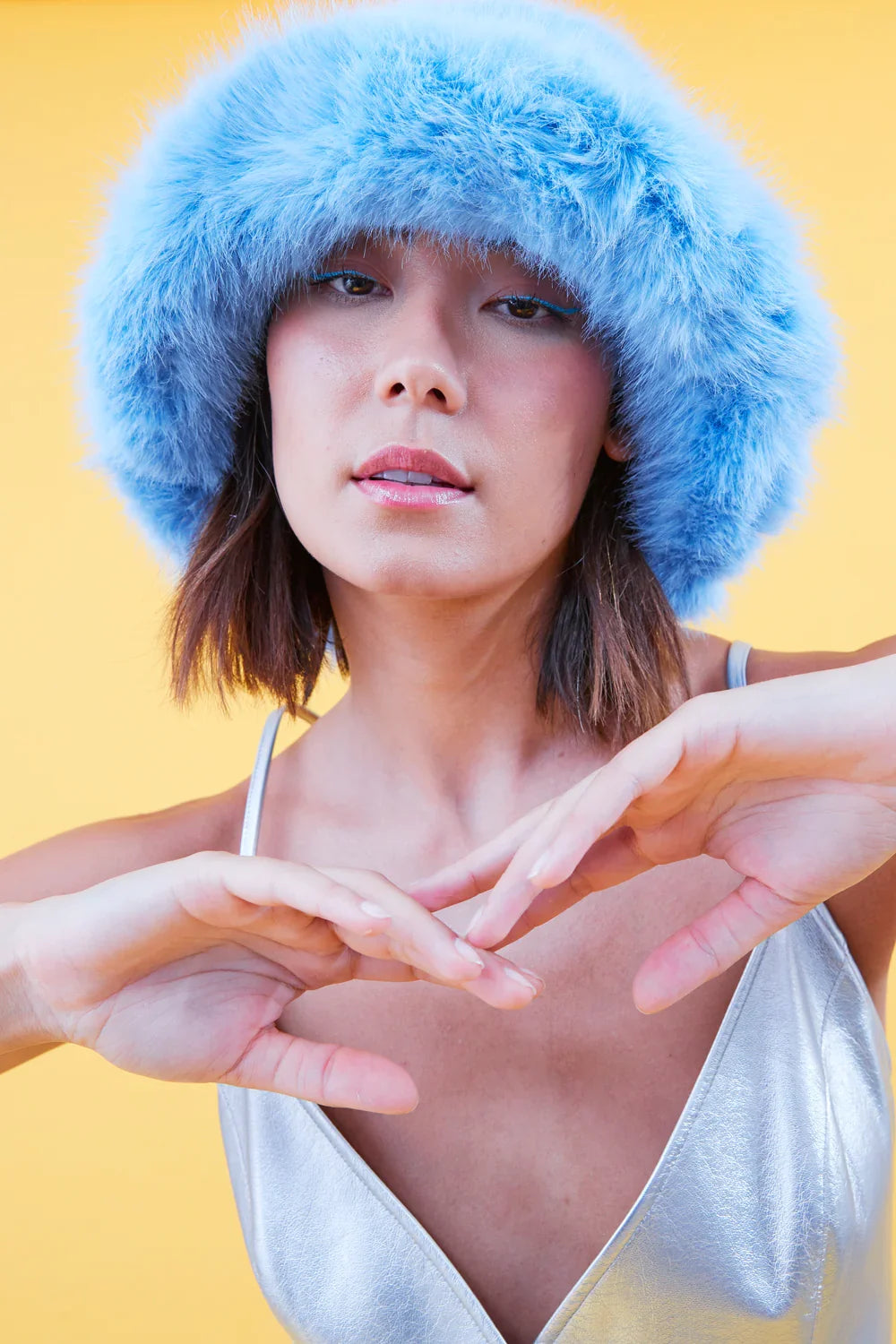 Light blue faux fur bucket hat, close-up of fluffy pile and brim