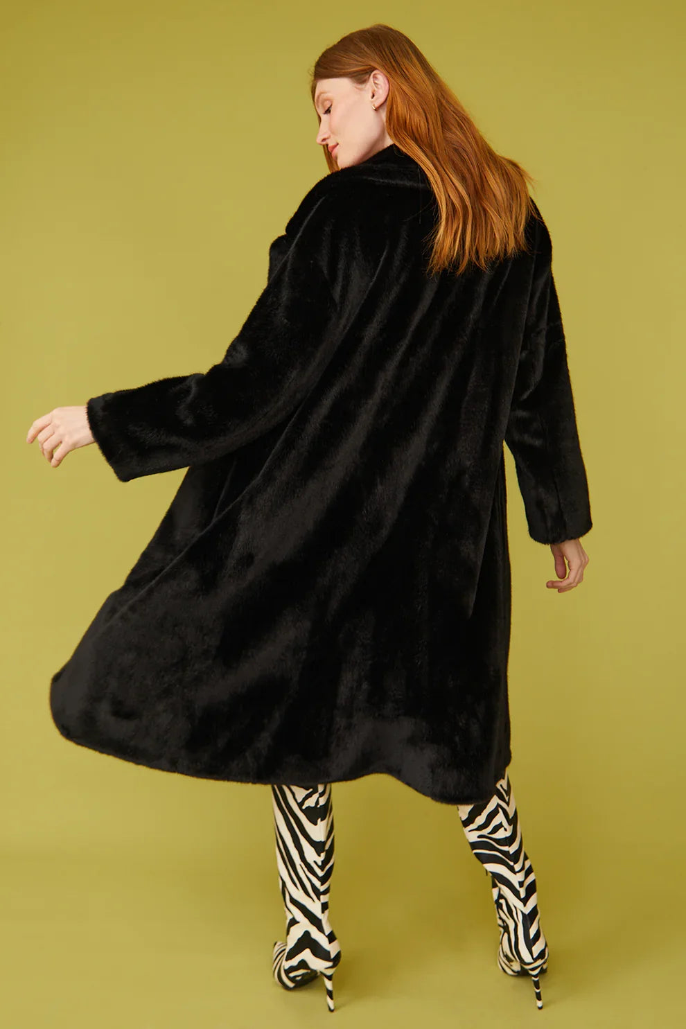 Black faux fur maxi coat, back view with long sleeves and flared hem