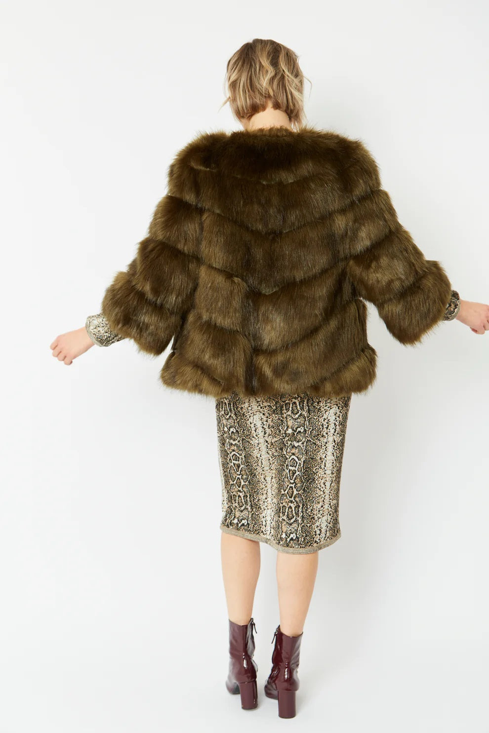 Dark green faux fur hooded coat with tiered back panels and short cropped length