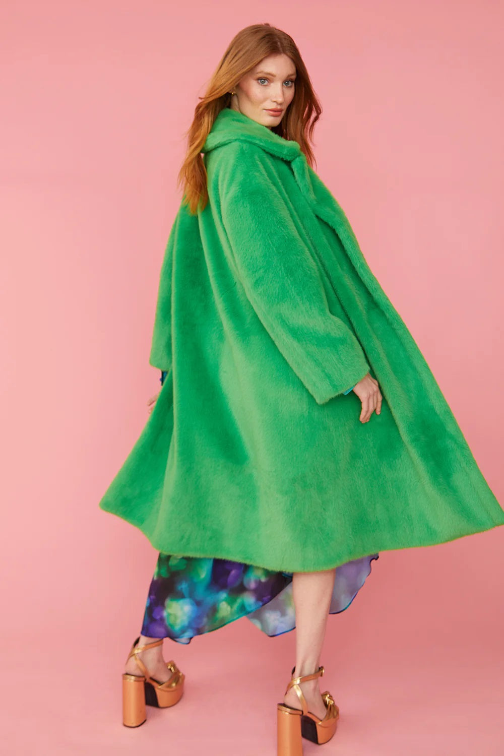 Green faux fur maxi coat with hooded neckline and flowing A-line silhouette