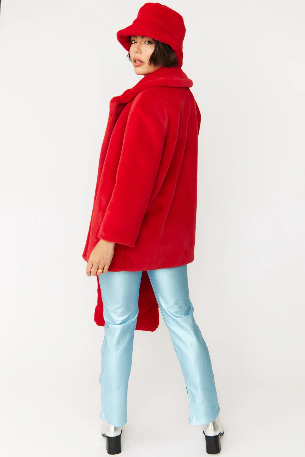 Red faux fur bucket hat, angled side view with short brim