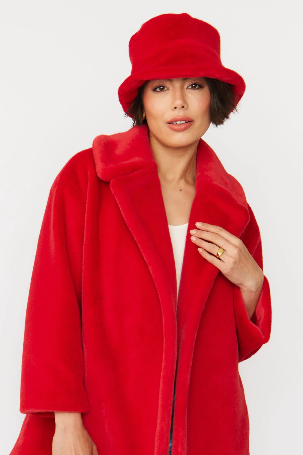 Red faux fur bucket hat with soft rounded crown and short brim
