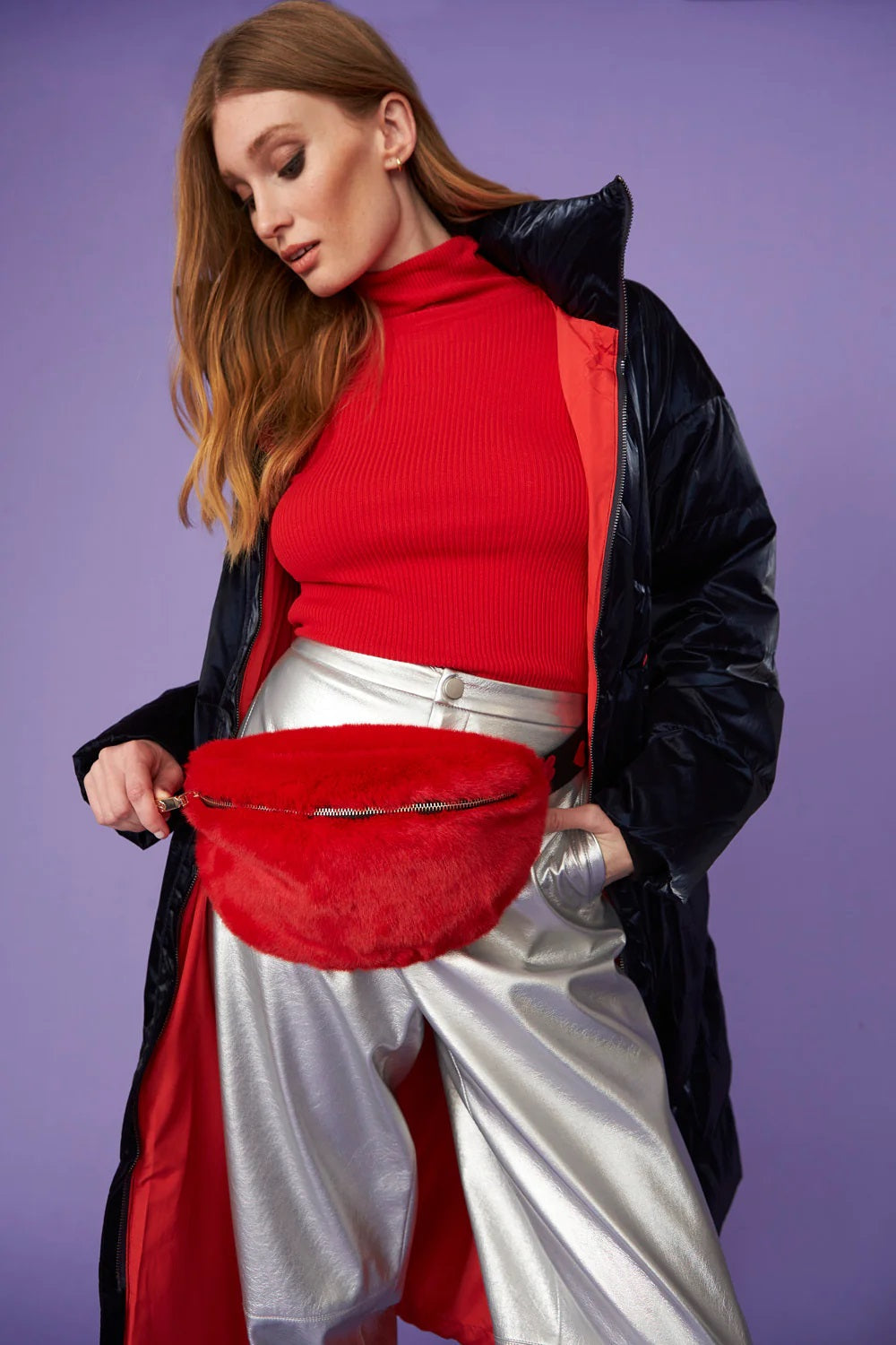 Red faux fur bum bag with black strap, worn at waist