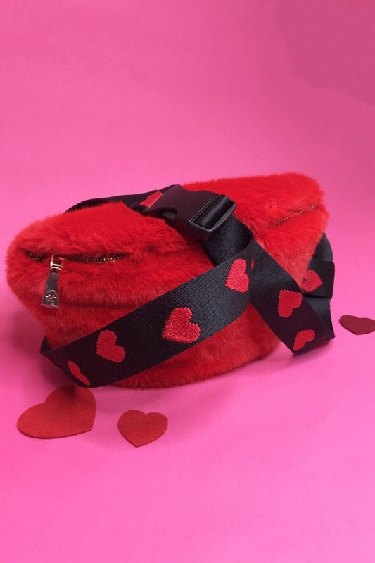 Red faux fur bum bag with black heart-pattern strap and zip pocket