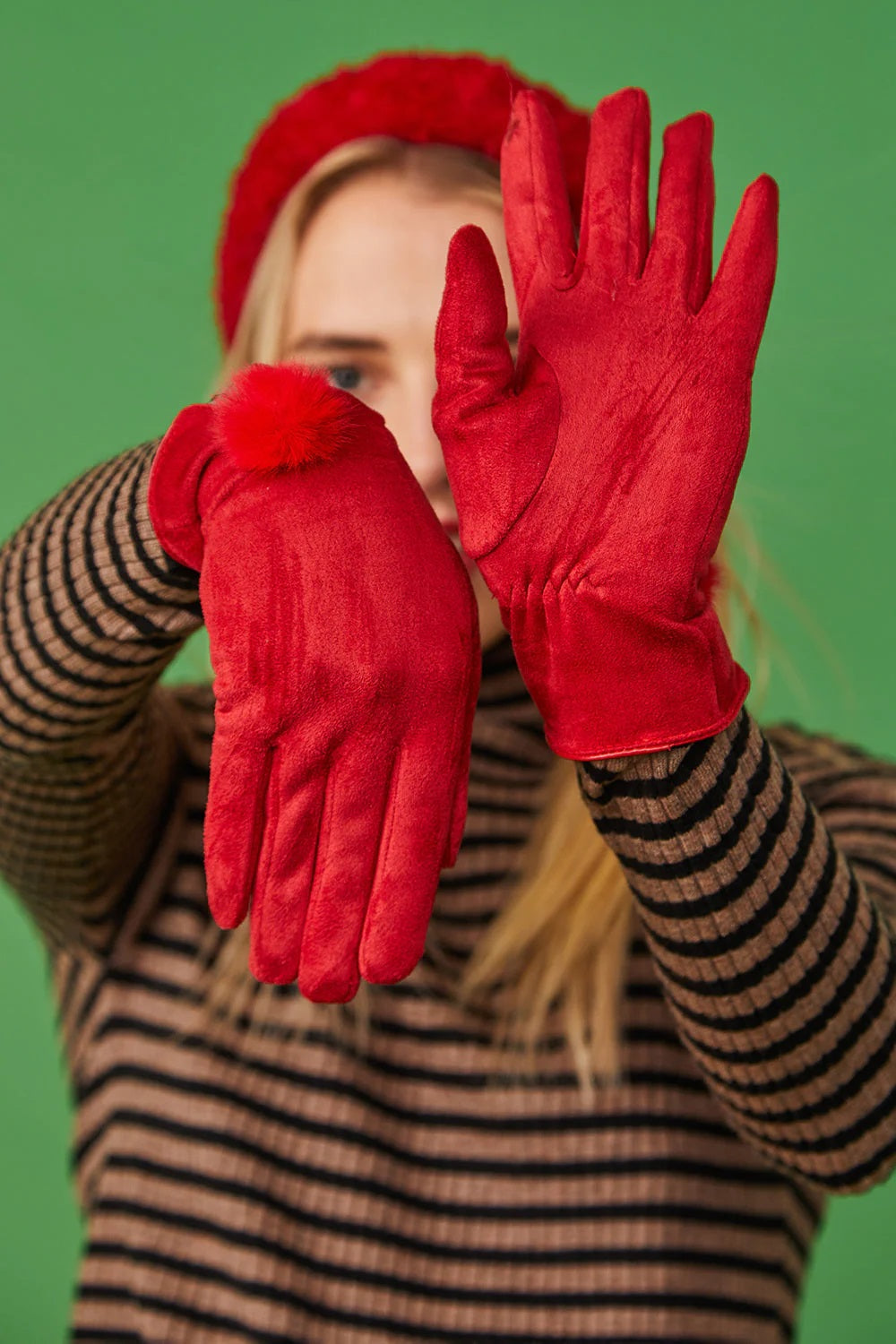 Red faux suede gloves with fuzzy fur pom at the cuff