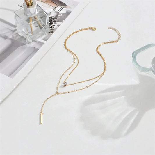 Gold double-layer Y necklace with small stone accents and long bar charm