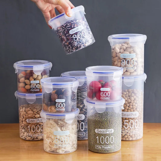 Set of transparent plastic sealed food storage jars with snap lids, holding mixed dry grains