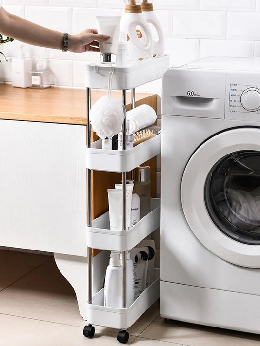 White 3-tier rolling utility cart with open shelves and caster wheels next to a washer