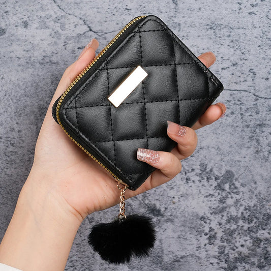 Black quilted card coin purse with metal clasp, chain, and black pom-pom