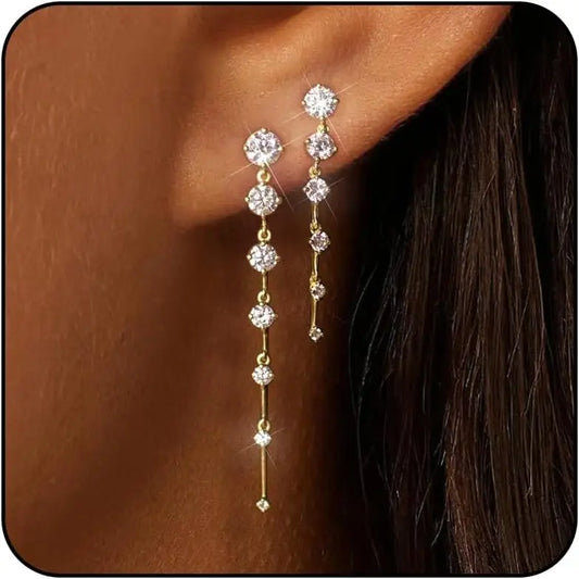 Gold-plated dangle earrings with three round CZ stones and dangling chain drops
