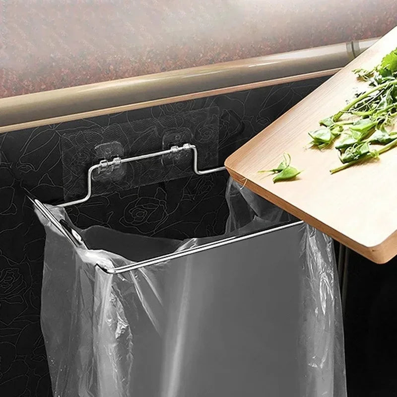 Stainless door trash can rack holding a black garbage bag on metal clips