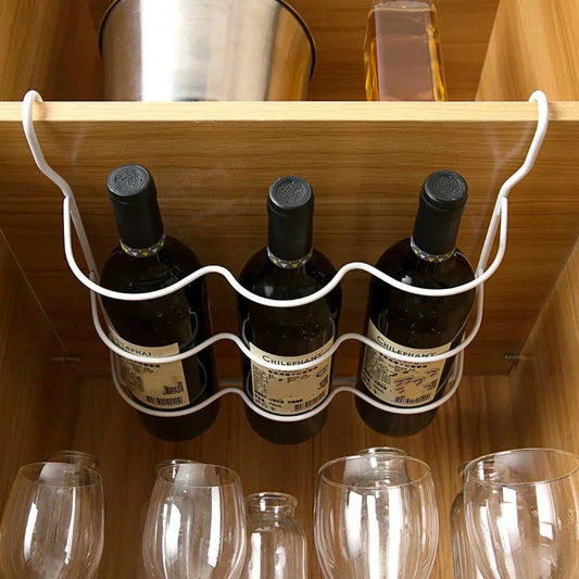 White refrigerator bottle rack organizer with curved supports holding three bottles under shelf.