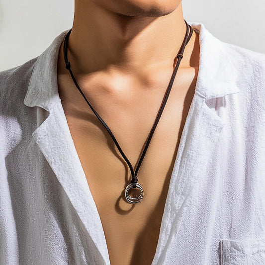 Adjustable black rope necklace with silver-toned circle ring pendant on model