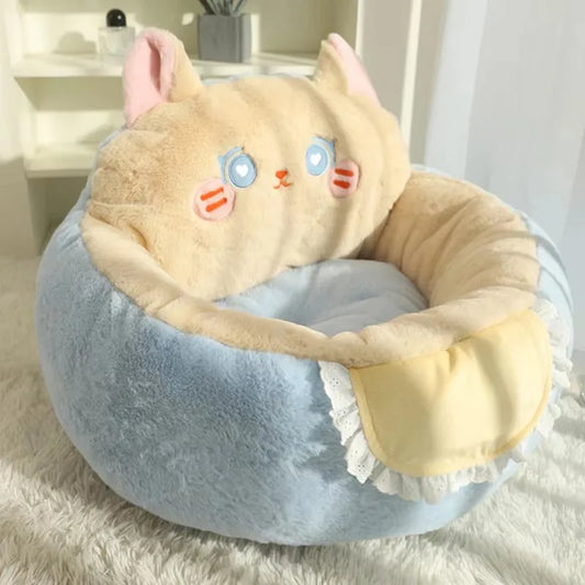 Cat sofa-style pet bed with beige face, blue accents, and plush round bolster
