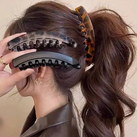 Tortoiseshell banana hair clip with clear teeth and black inner comb detail