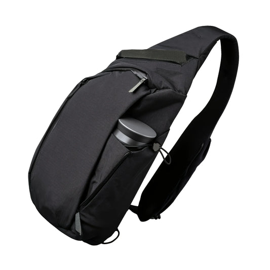 Black sling backpack-style chest bag with padded strap and front zip pocket